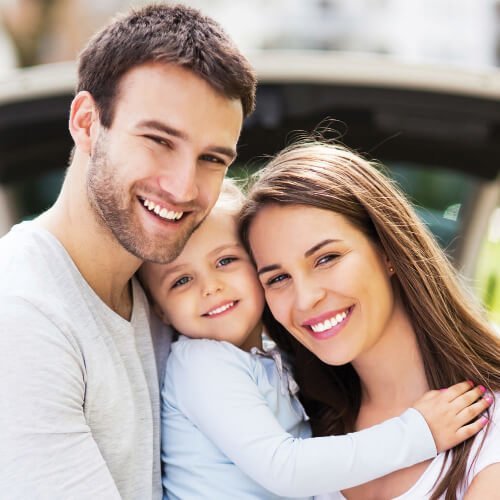 Family smiling after visiting the dentist