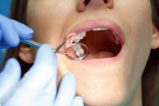 Dentist looking at woman's gums for gum disease