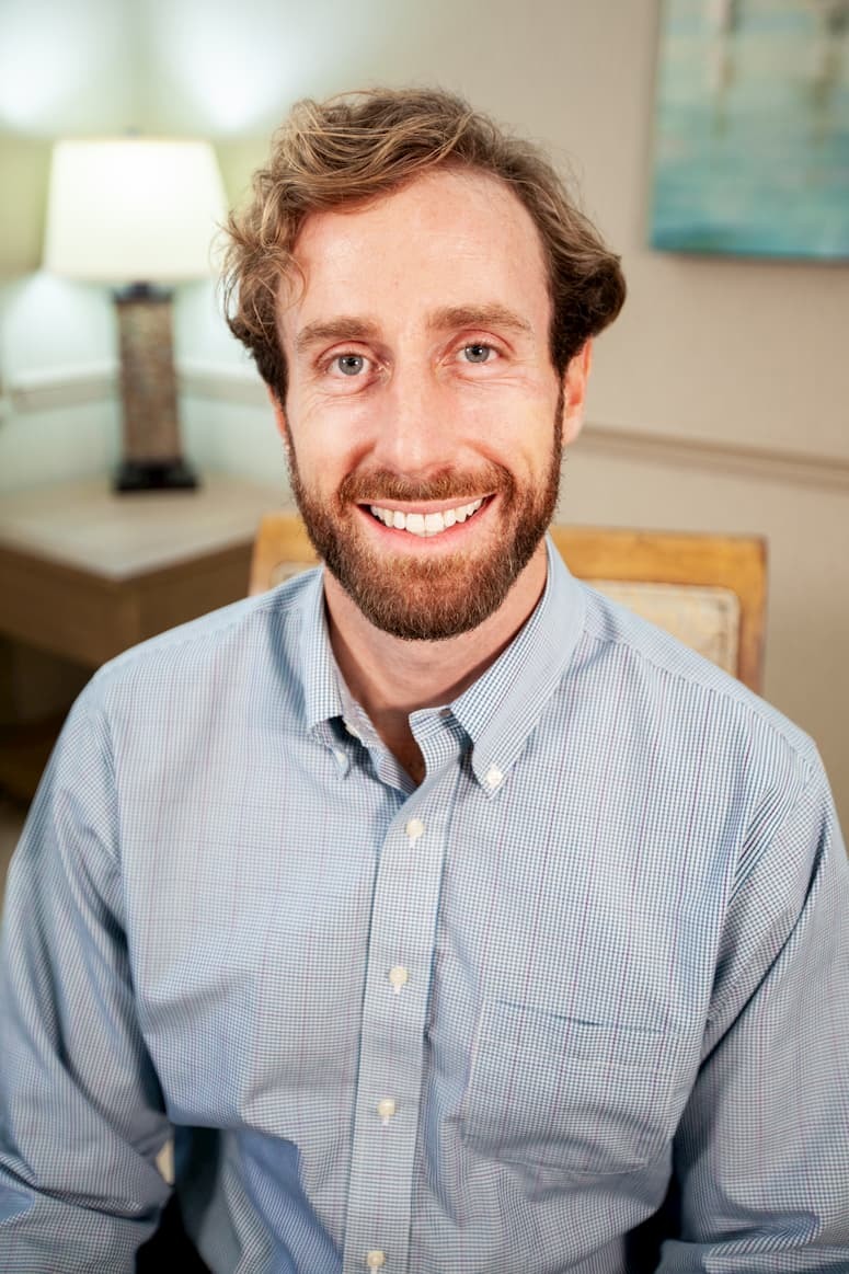 Dr. Farnham sitting in a chair smiling
