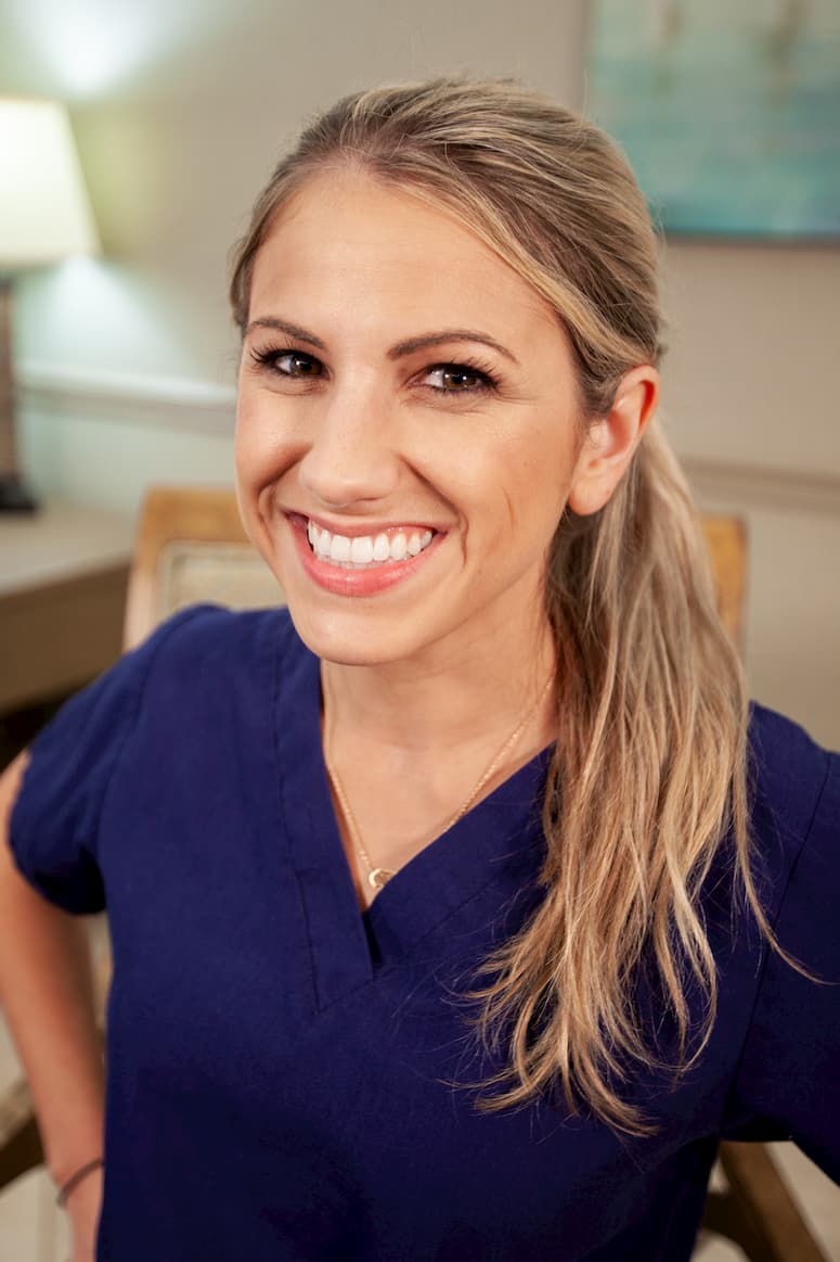 Dr. Farnham sitting in a chair smiling