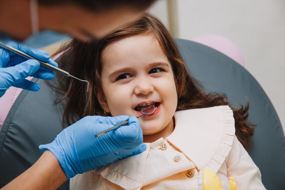 Little girl getting her teeth cleaned