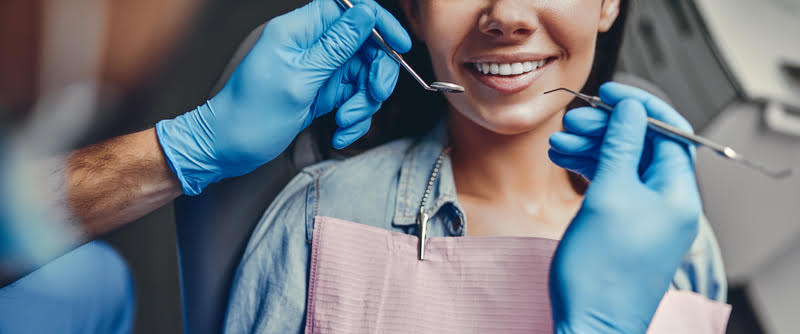 A woman receiving a dental check-up at a general dentist's office
